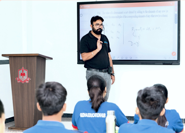 Teacher writing on a whiteboard